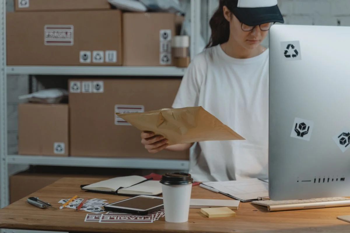 Someone packing orders at a fulfilment desk